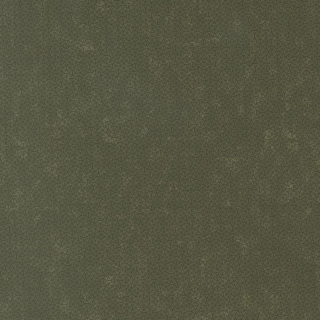 Close-up of a textured dark green fabric surface.