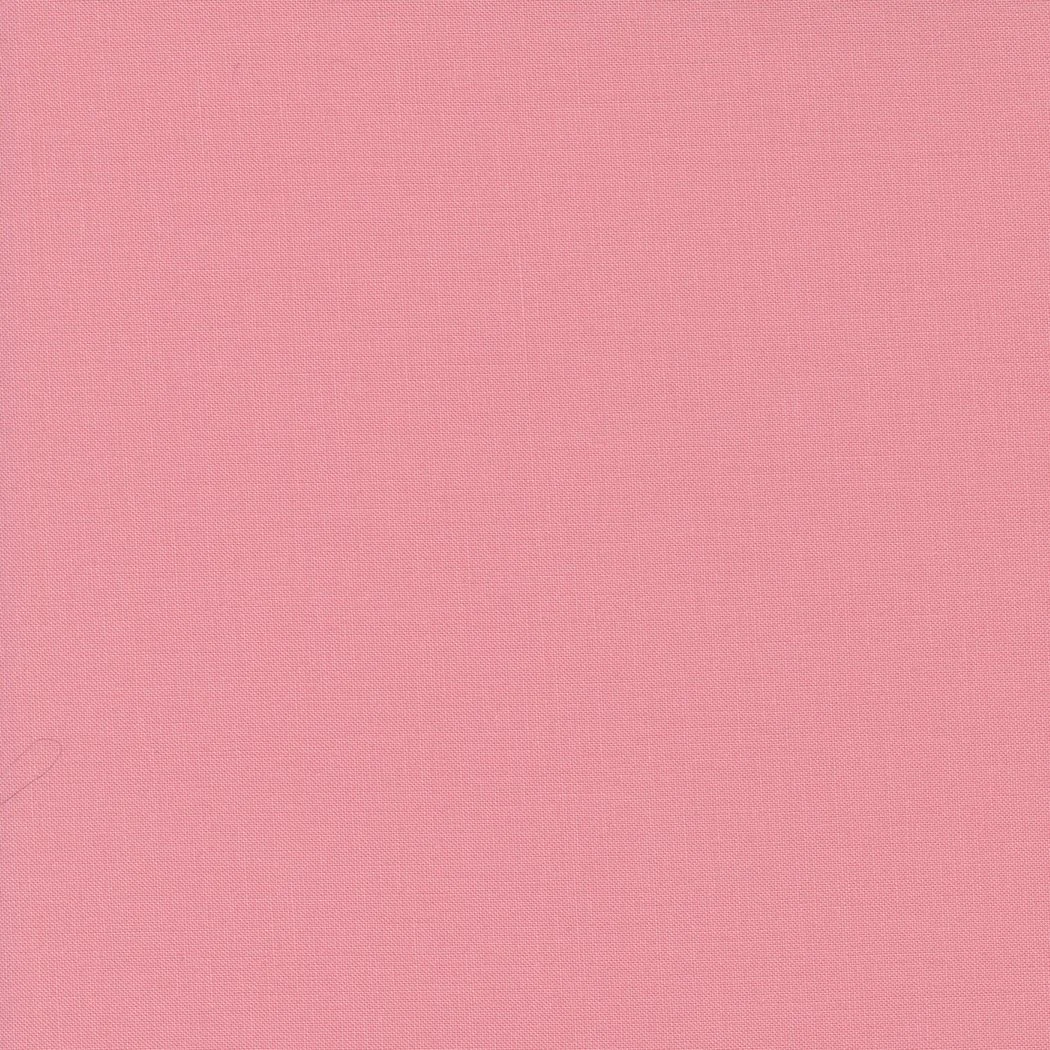 A close-up of pink fabric with a textured pattern.