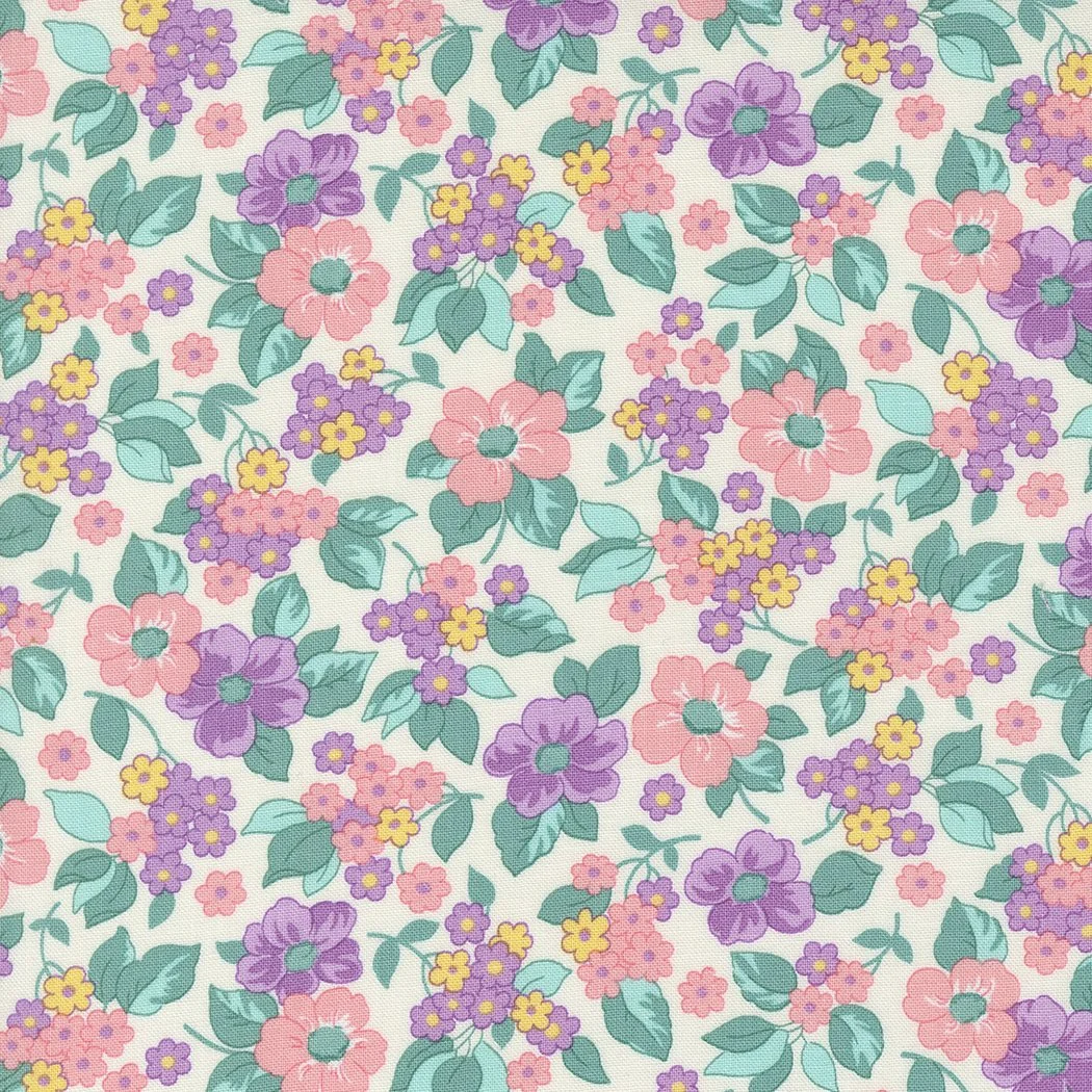 A fabric pattern with a floral design featuring pink, purple, and yellow flowers with green leaves on a light background.