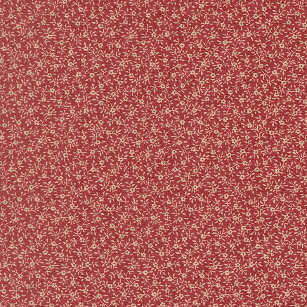 Red fabric with a small beige floral pattern