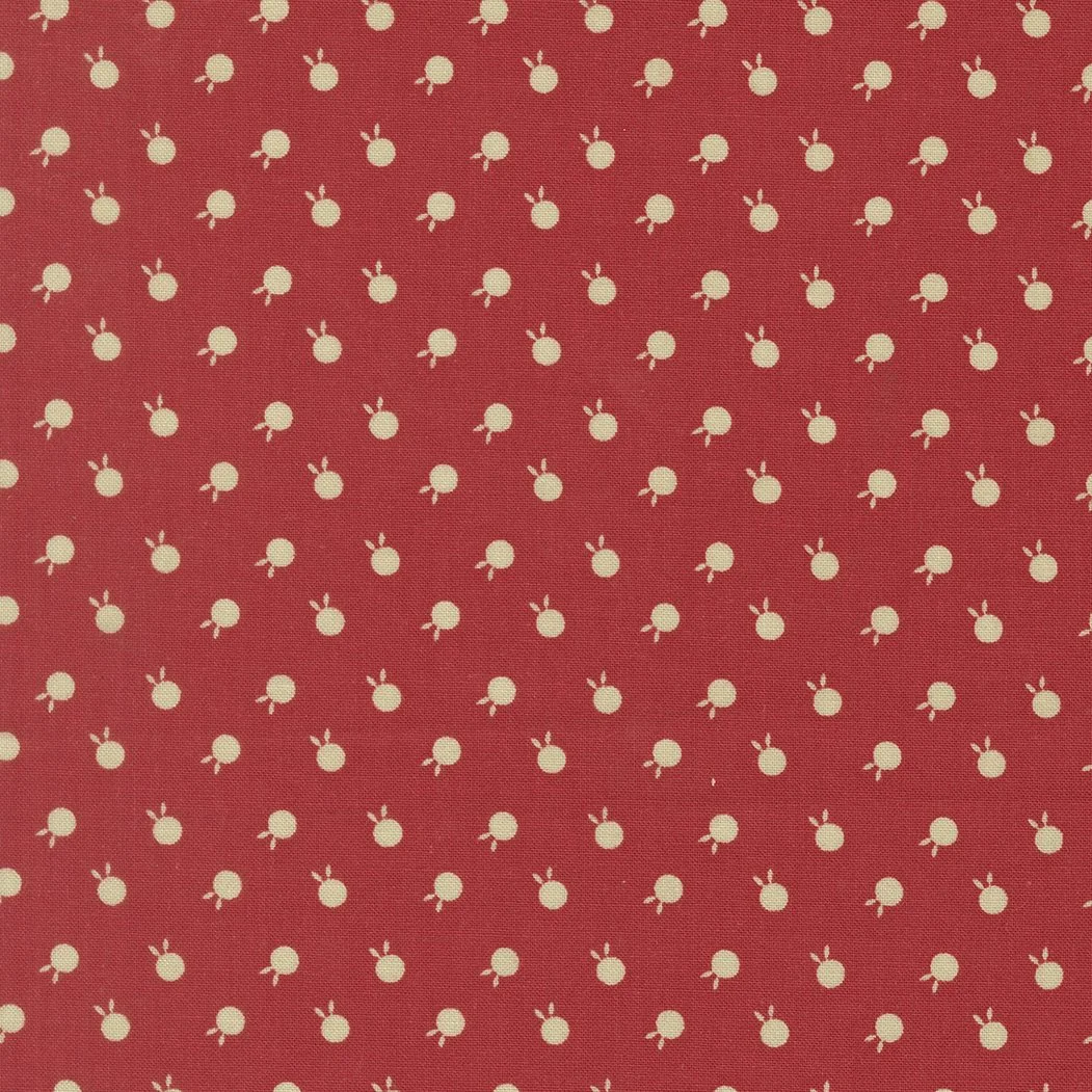 Red fabric with small white bunny patterns.