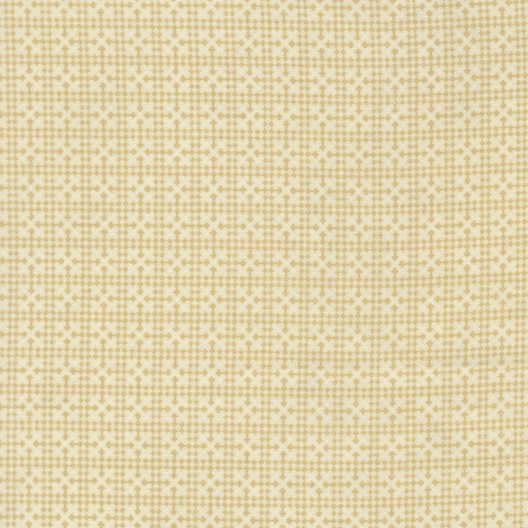 Close-up of a beige fabric with a tiny cross-stitched pattern in a slightly darker beige color.