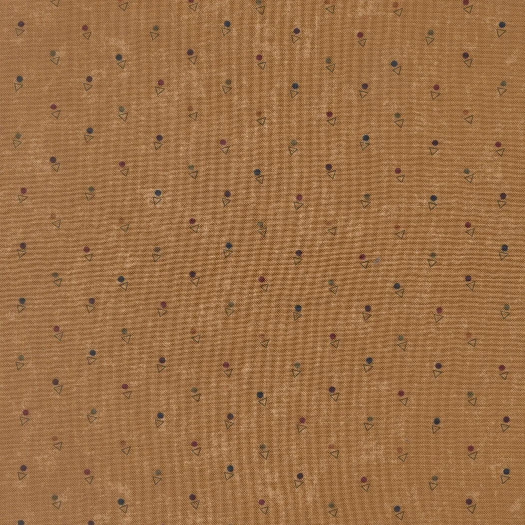 Close-up of textured brown fabric with small, colorful, repeating ellipse and triangle pattern.