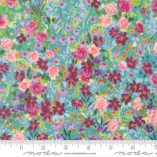 A colorful floral fabric pattern with pink, purple, and blue flowers and green foliage, with a ruler at the bottom measuring in inches.