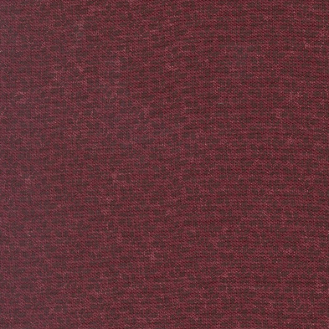 Red fabric with a black leopard print pattern.