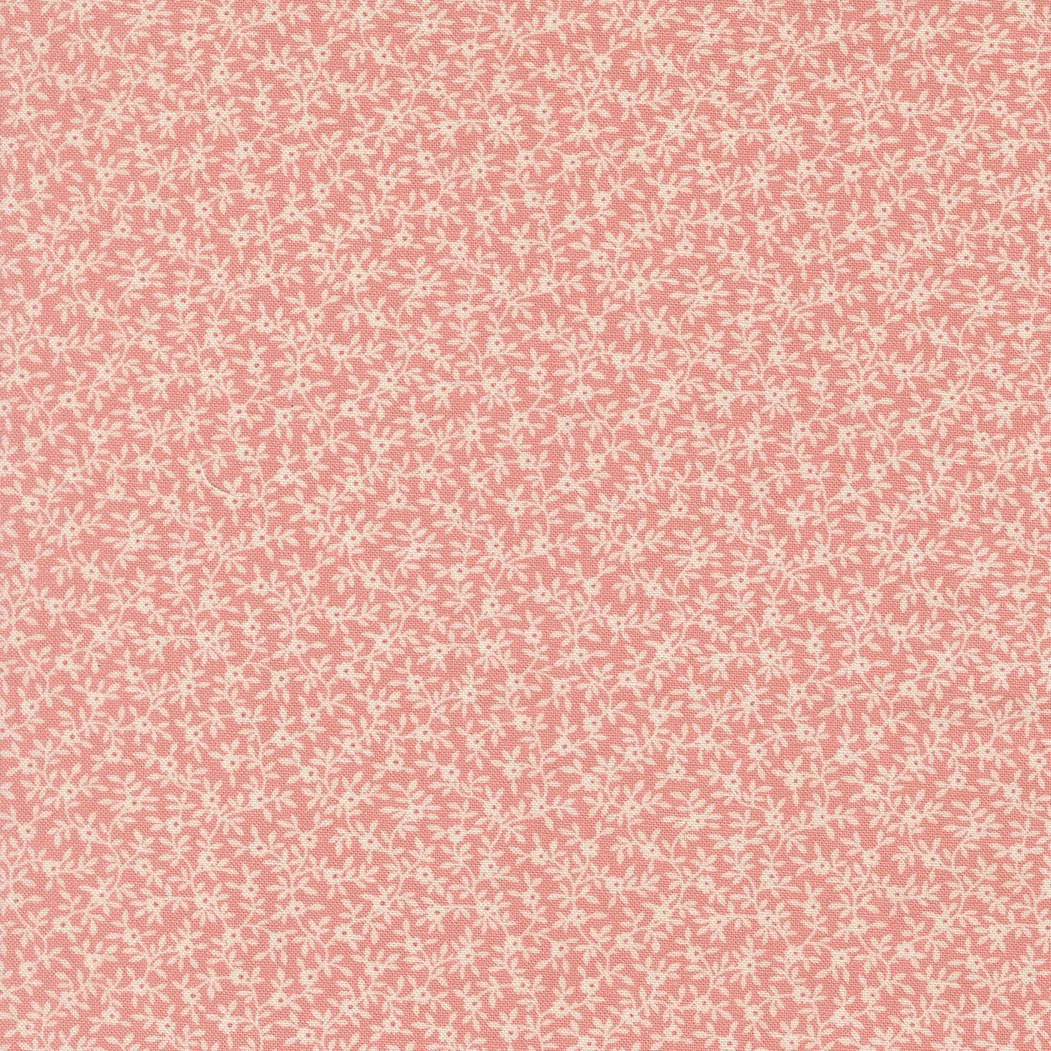 A pink and white fabric with a small, intricate, snowflake-like pattern.