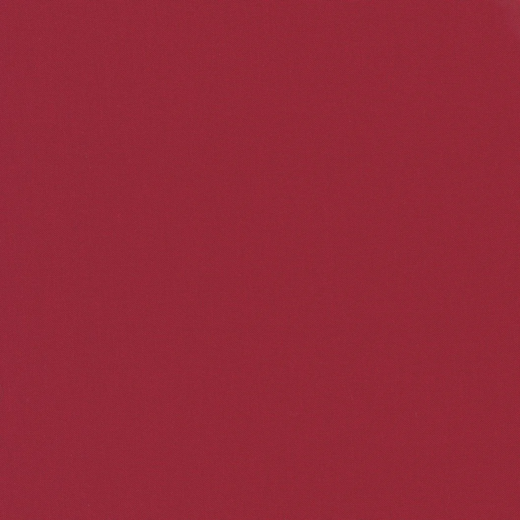 A plain, solid maroon-colored background.