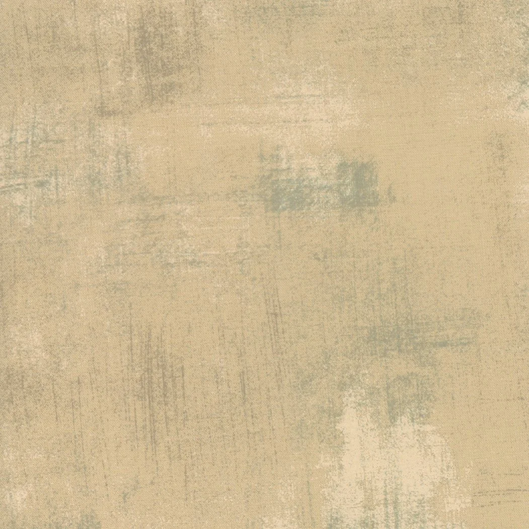 A textured beige surface with faint brushstrokes and subtle color variations.