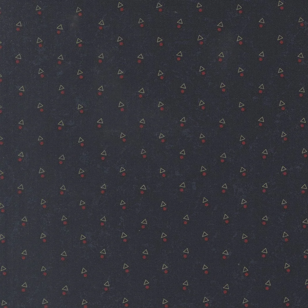 Dark fabric with small repeating geometric pattern of green triangles and red circles.