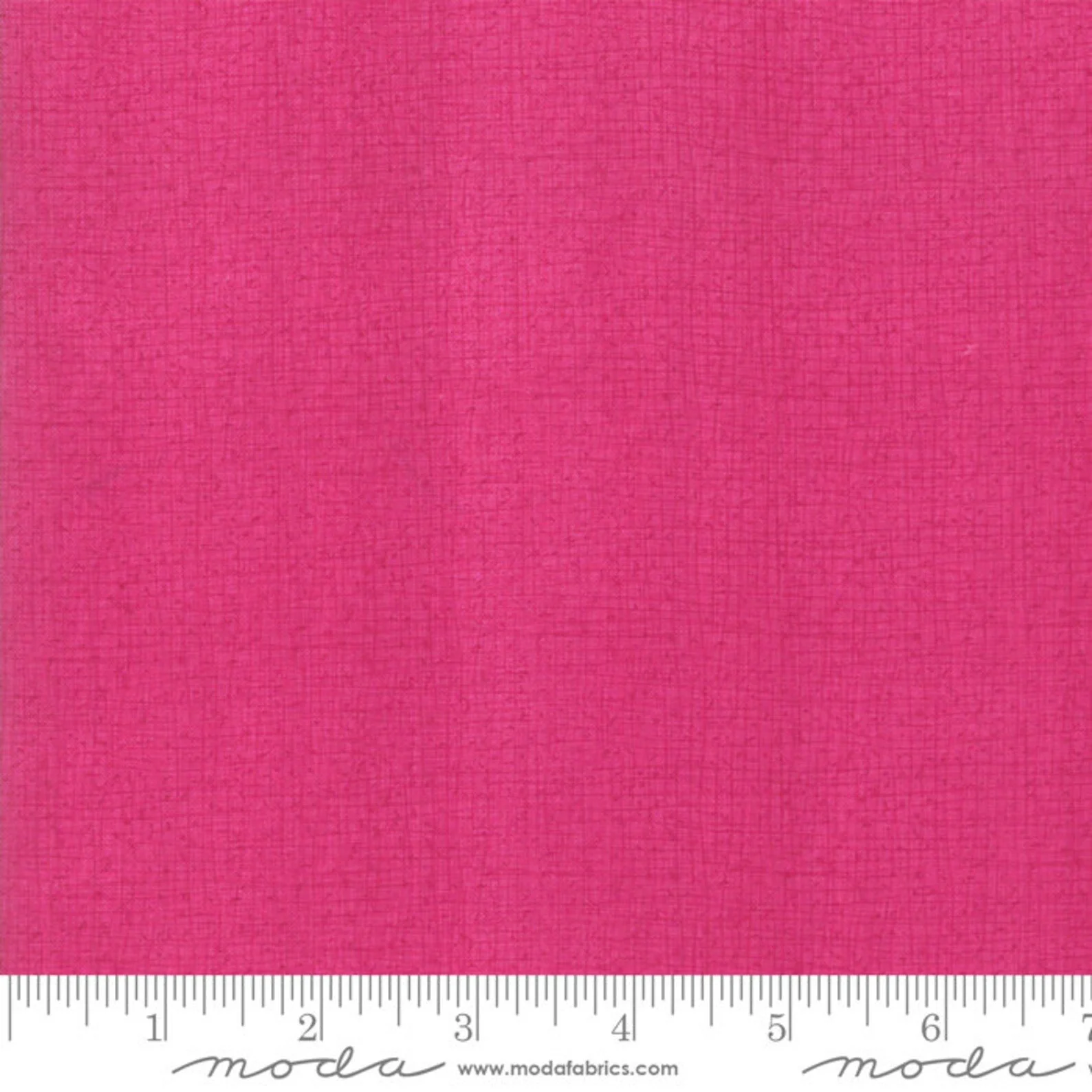 Close-up of pink woven fabric with a textured appearance.