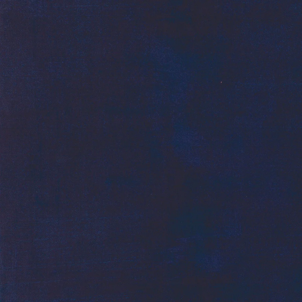 A dark night sky with some faint stars visible.