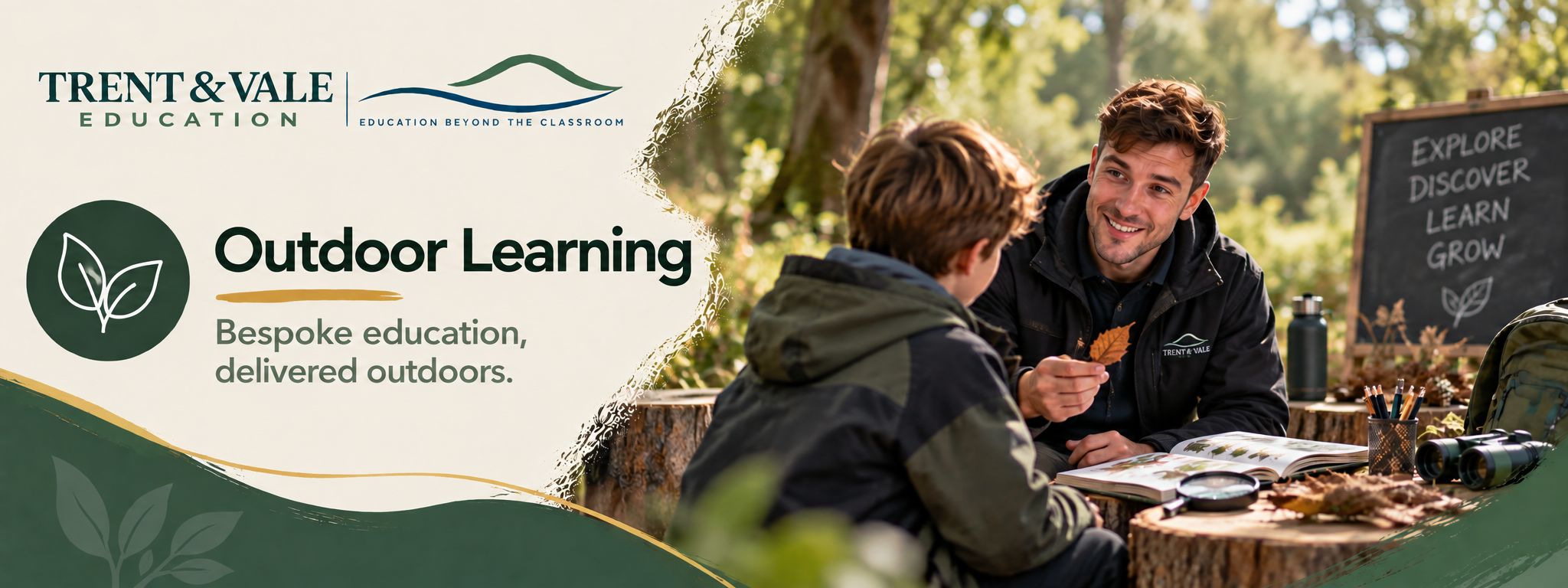 A man teaching a young boy outdoors during the daytime, with educational materials and a blackboard that says 'explore, discover, learn, grow' in a natural setting with trees and sunlight.