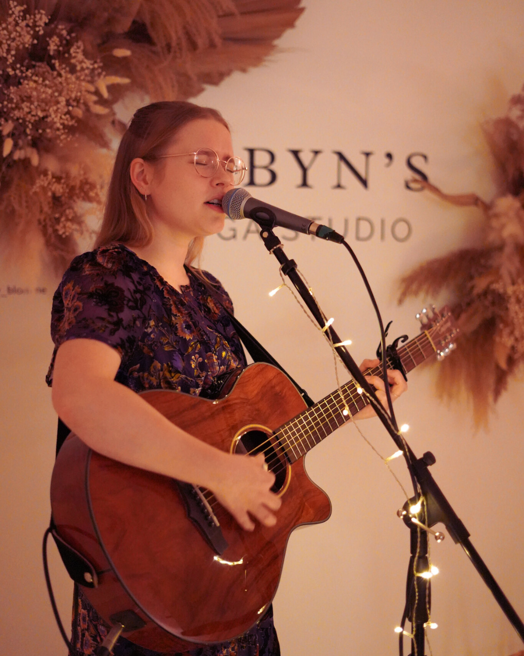 poppy rose performing live acoustic music at a yoga studio Christmas party in bath