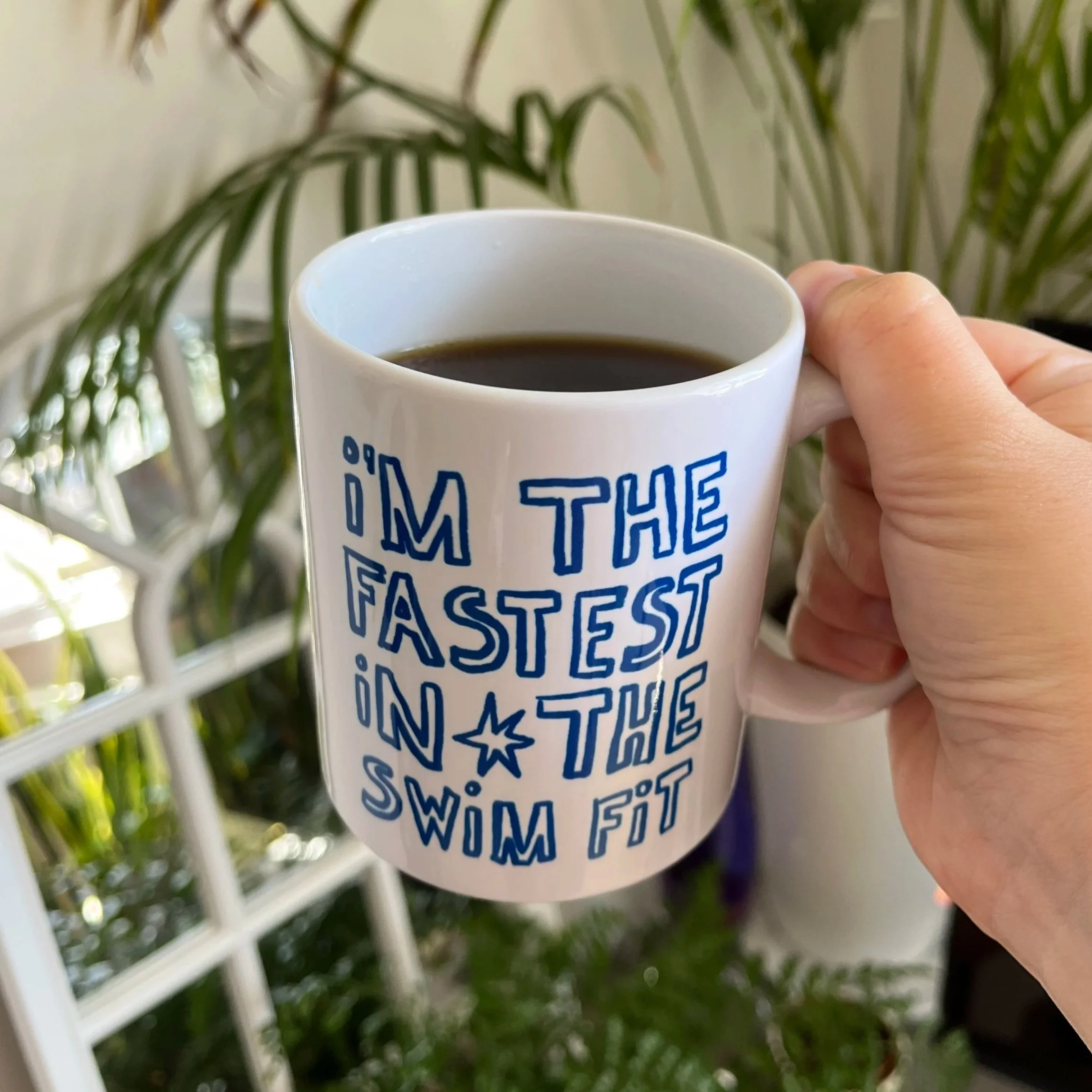 mug of coffee reading "I'm the fastest in the swim fit" from Let's Go Swimming! by poppy rose