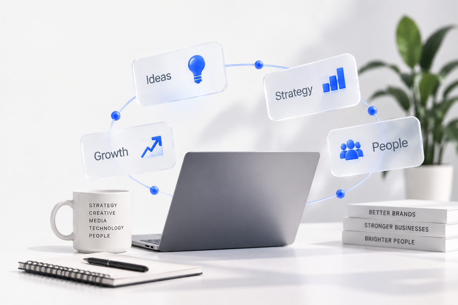 A desk workspace with a laptop, notebook, pen, and a coffee mug listing words like strategy, media, and technology. Floating in the air are digital infographic icons with words such as ideas, growth, strategy, and people, connected in a circular pattern, against a plain background with a plant on the side.