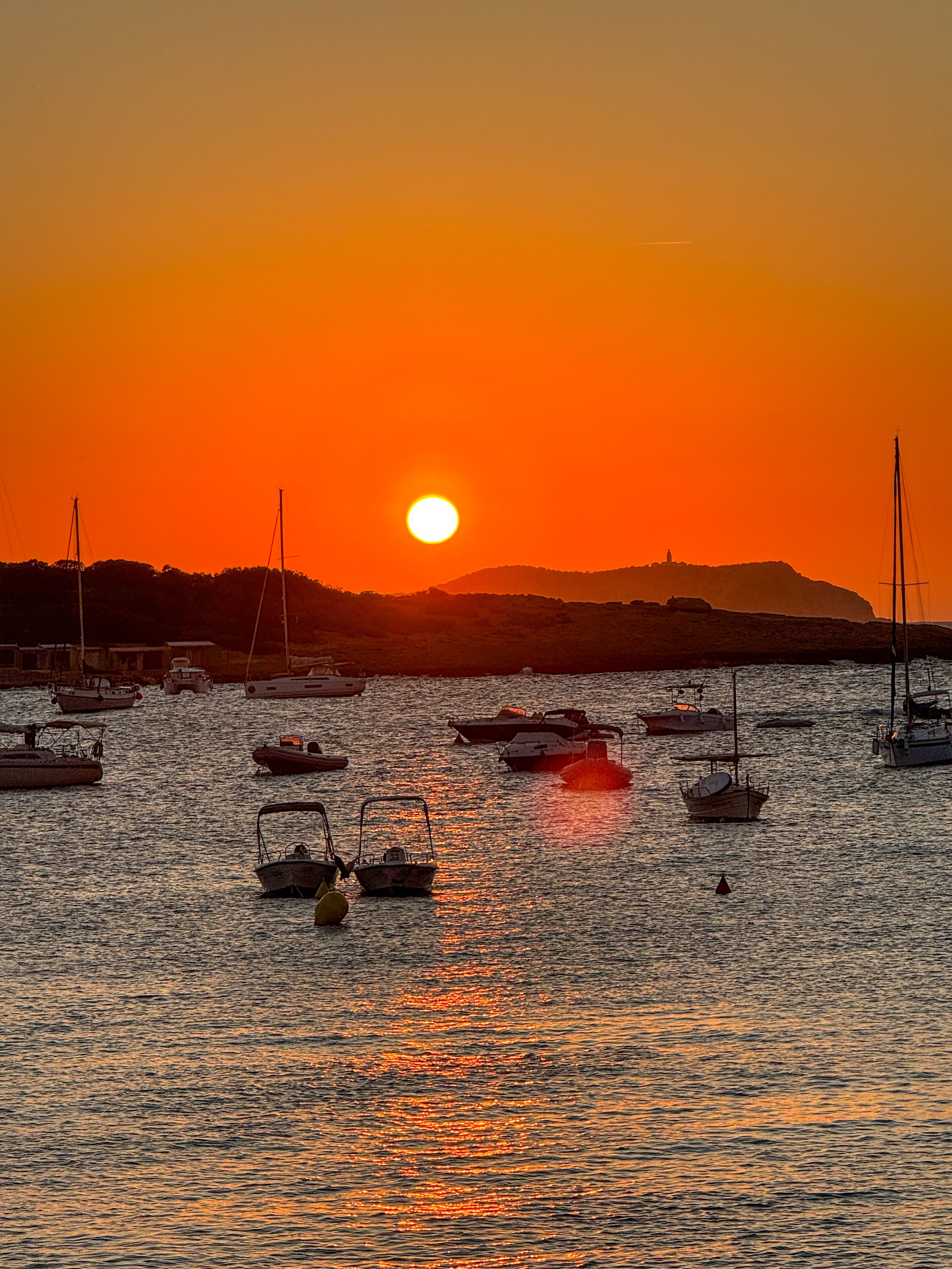 Orange sunset over a harbour full of moored boats