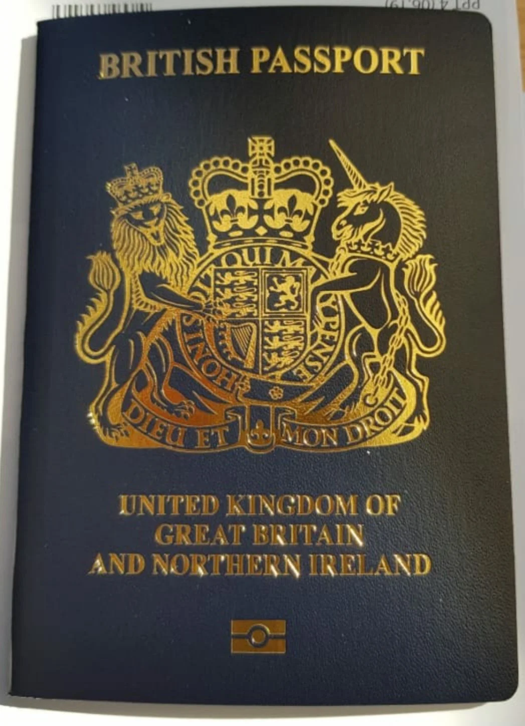 A dark blue British passport with its gold crest