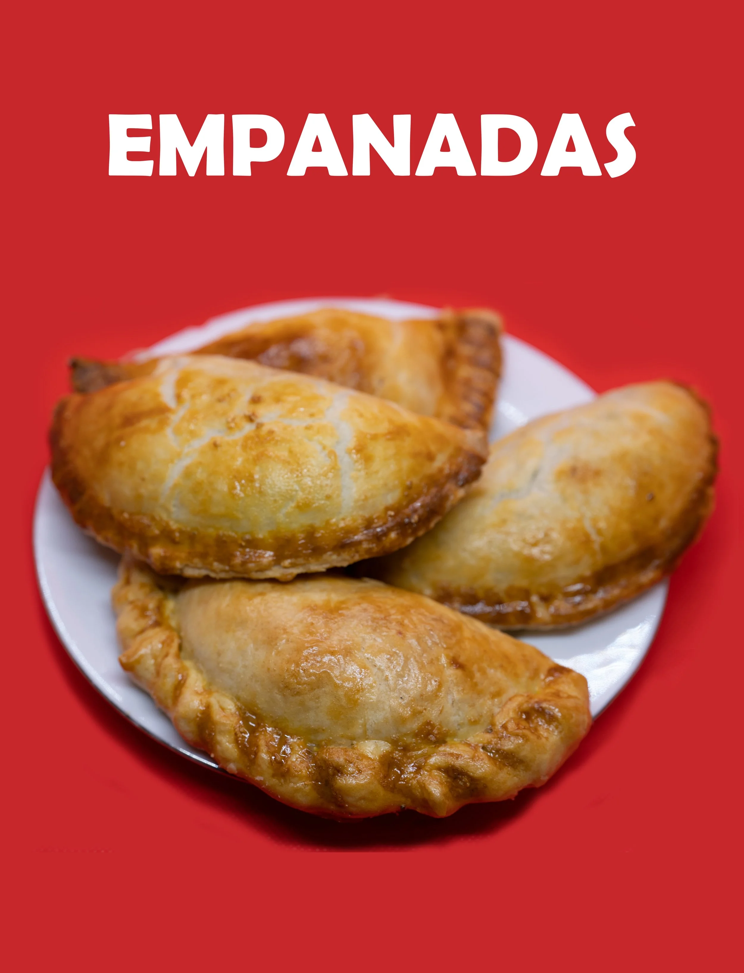 A white plate with four golden-brown Mexican empanadas on a red background.