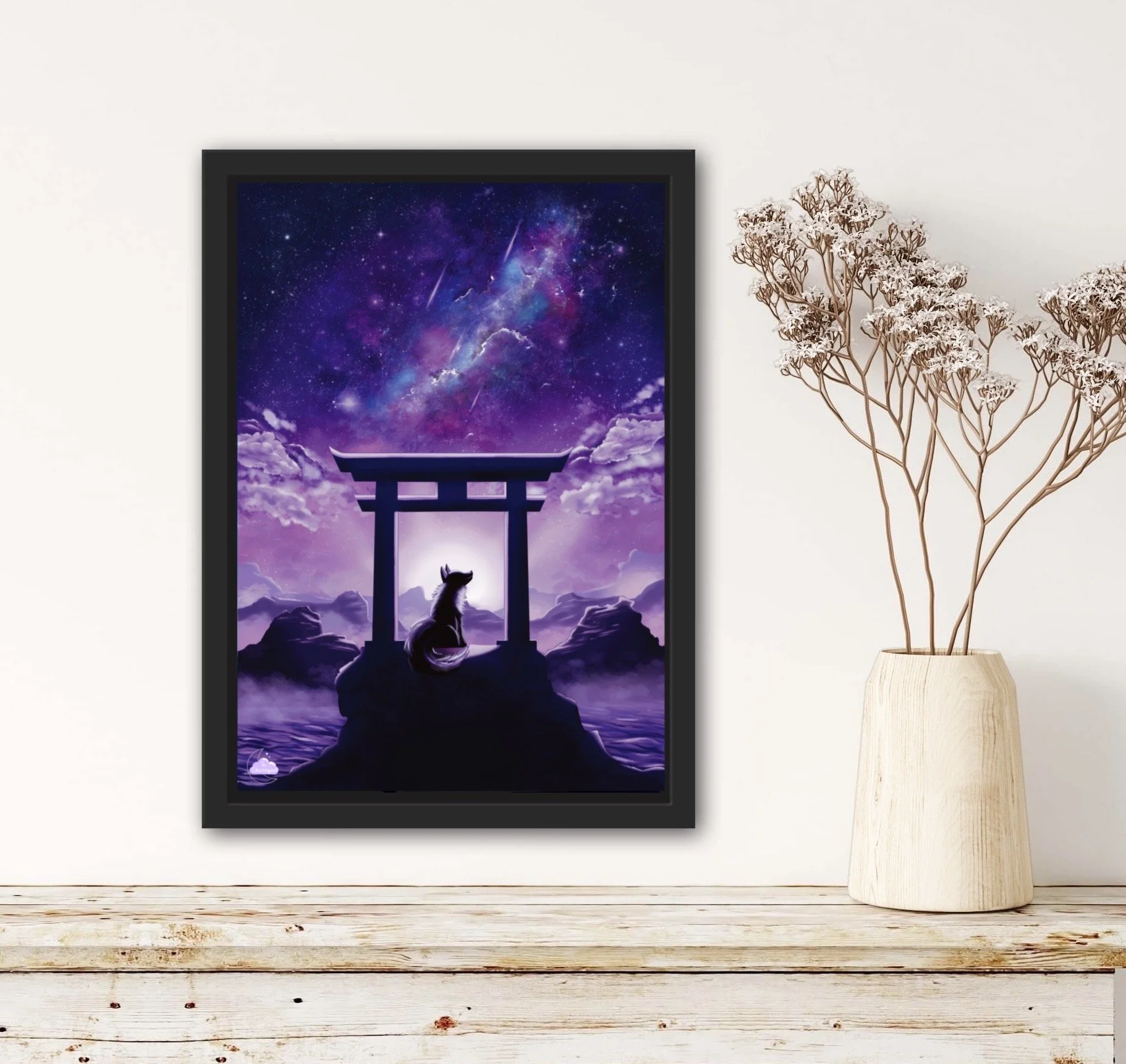 Framed digital artwork of a cosmic scene with purple and blue galaxy, shooting stars, a torii gate, a fox silhouette, and a reflected sky on water, on a white wall with a wooden floor and a tall, light-colored vessel with dry, branched plants inside.