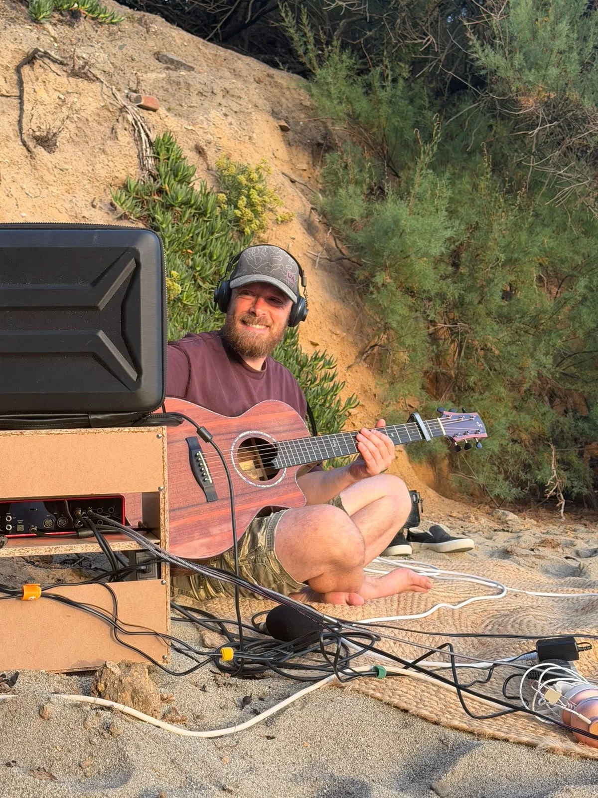 Mike Meinke playing acoustic guitar during an outdoor CMF session.