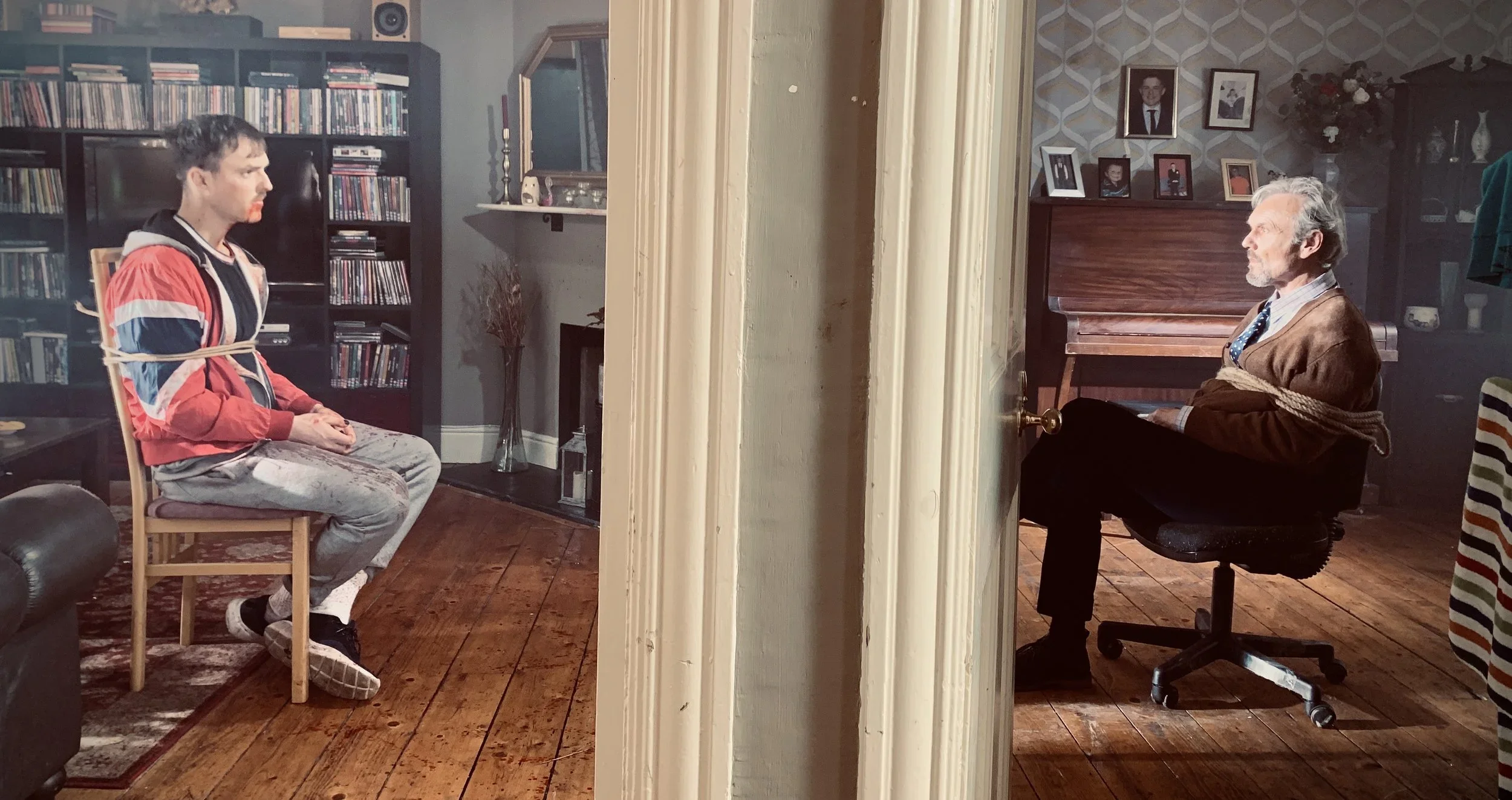 33+Eoin+Duffy+as+Deco_Anthony+Head+as+Henry_Martin+King+BTS+Still.webp