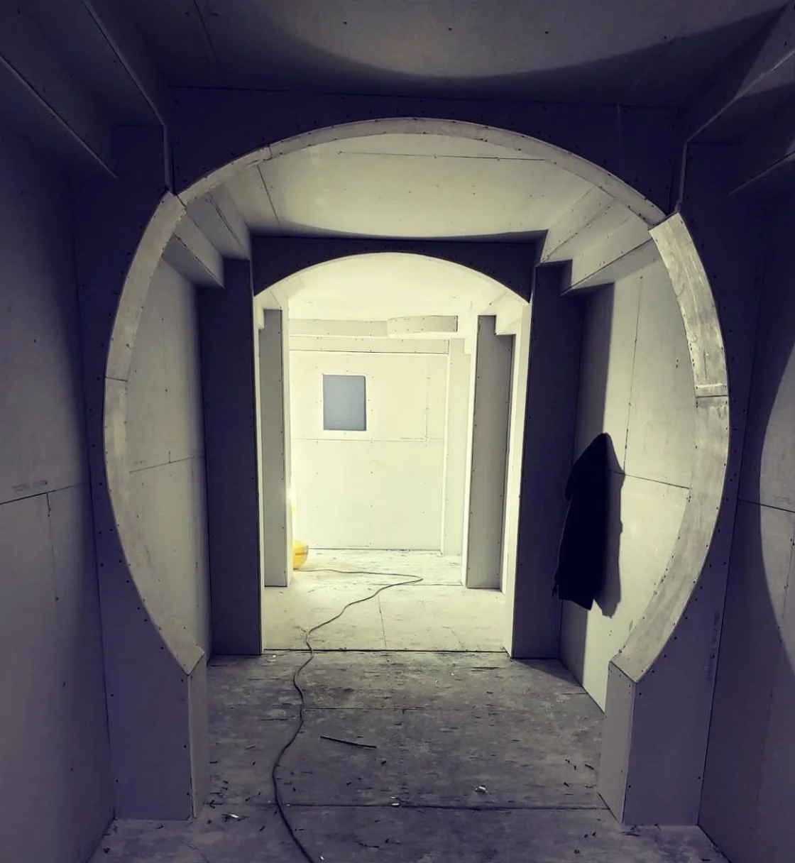 Custom curved drywall archway framed into a ceiling bulkhead