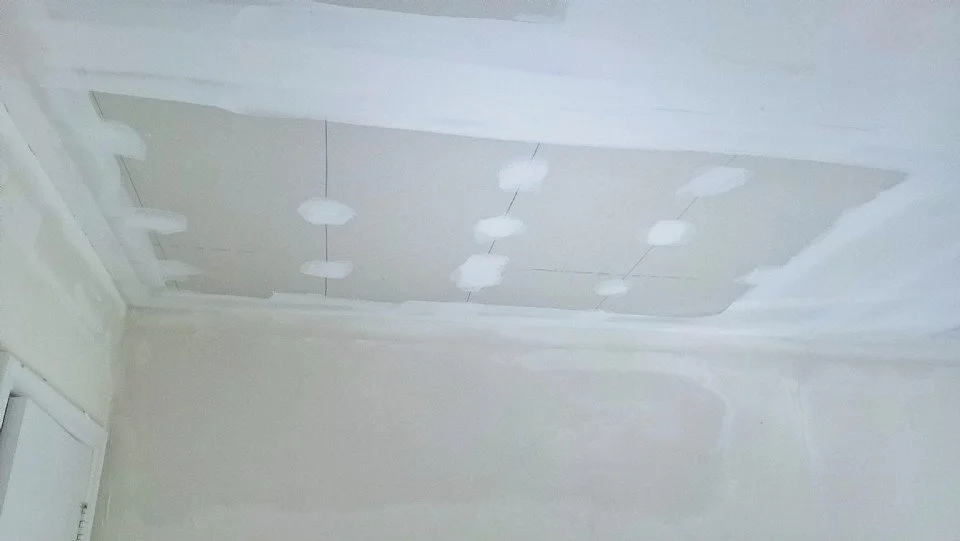 New ceiling drywall hung with screws and seams mudded