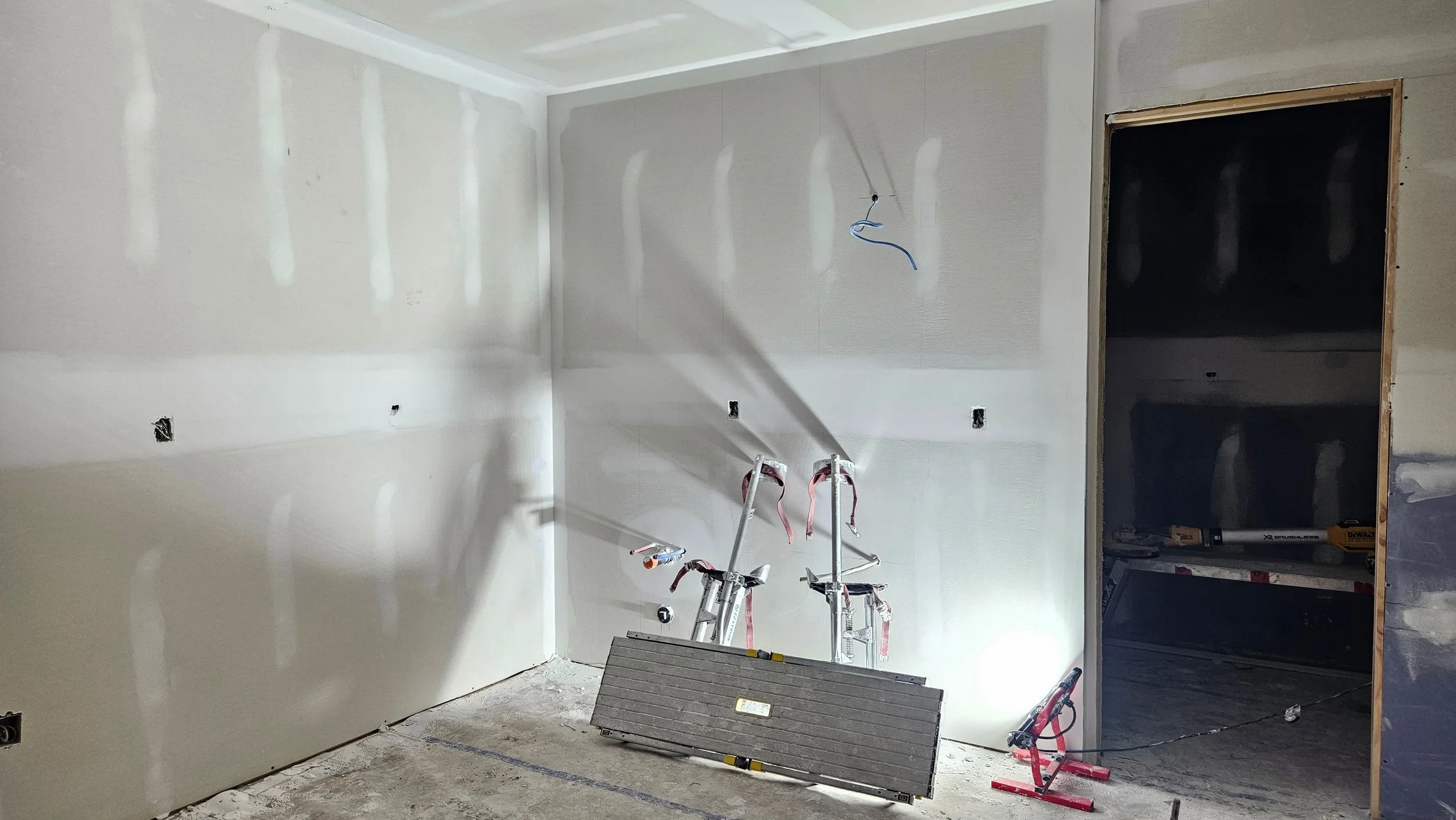 Garden suite kitchen wall boarded and taped with plumbing rough-in