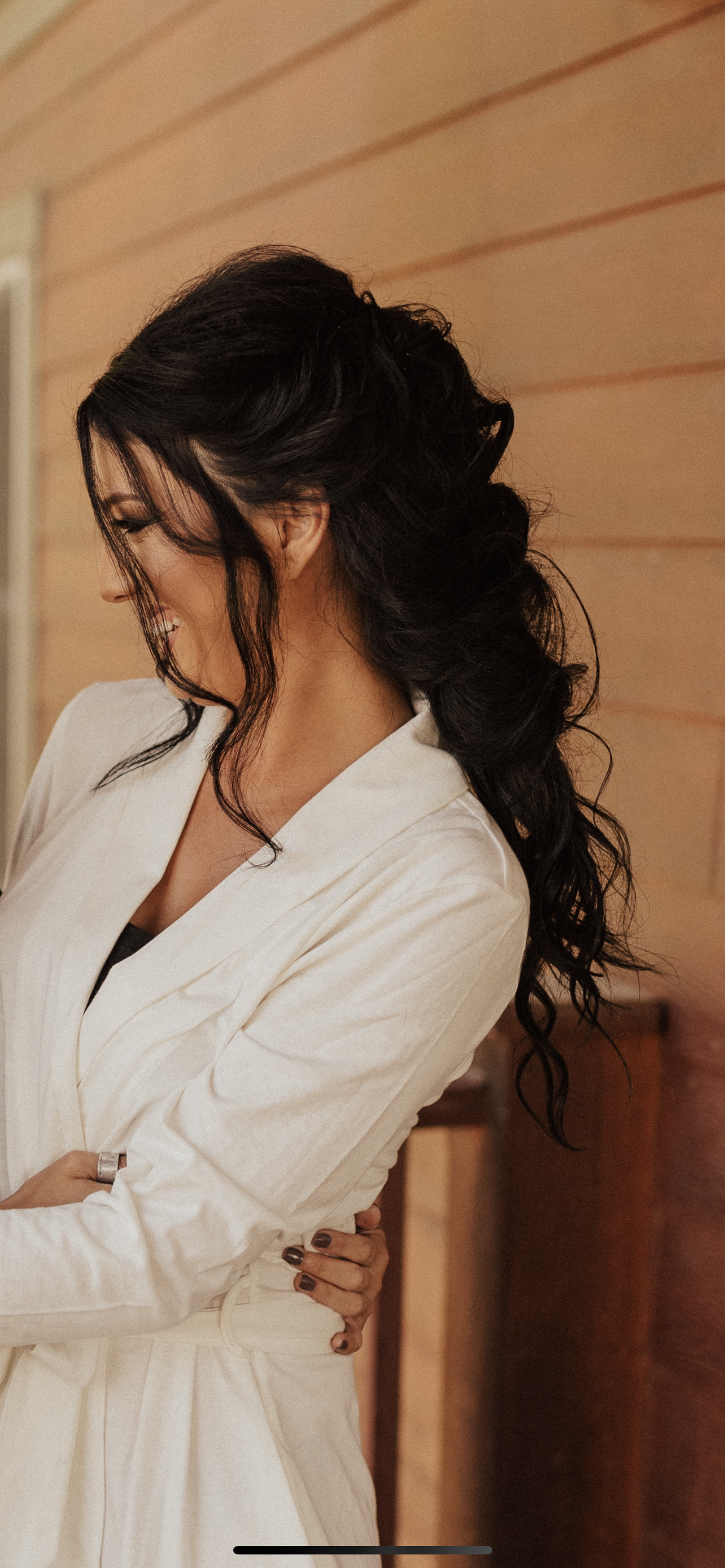 An image of a bride, smiling with Joy after getting her hair done at Mendocino bridal hair