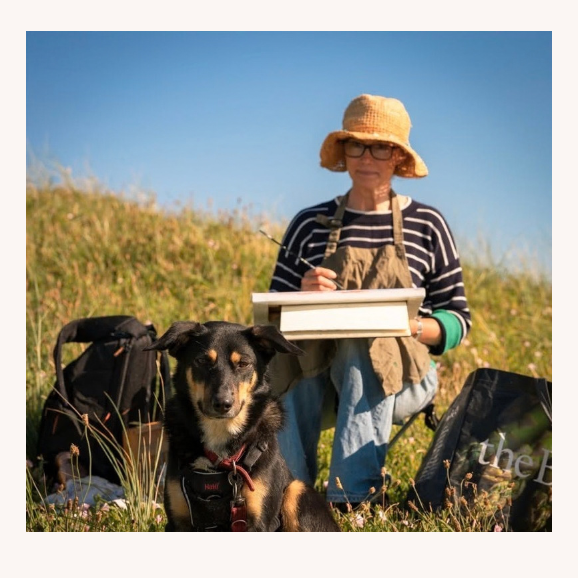 British artist Kate Wynne-Eyton painting plein air landscape art outdoors with her dog