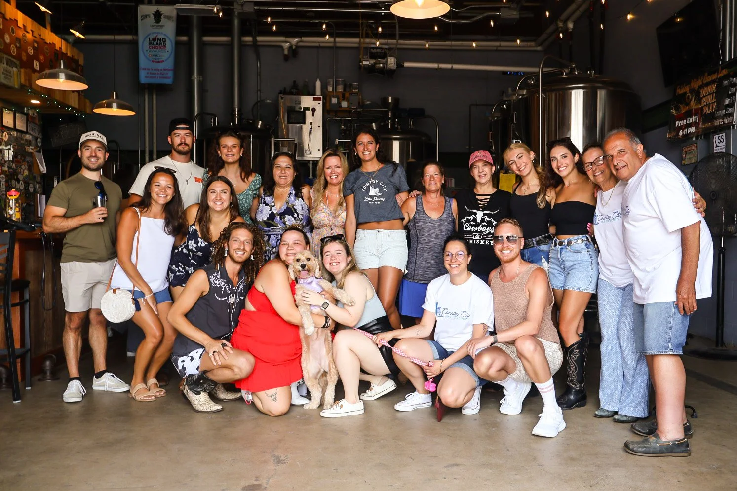 A group of people gathered inside a brewery for a line dance event. Country City's Kick off Party