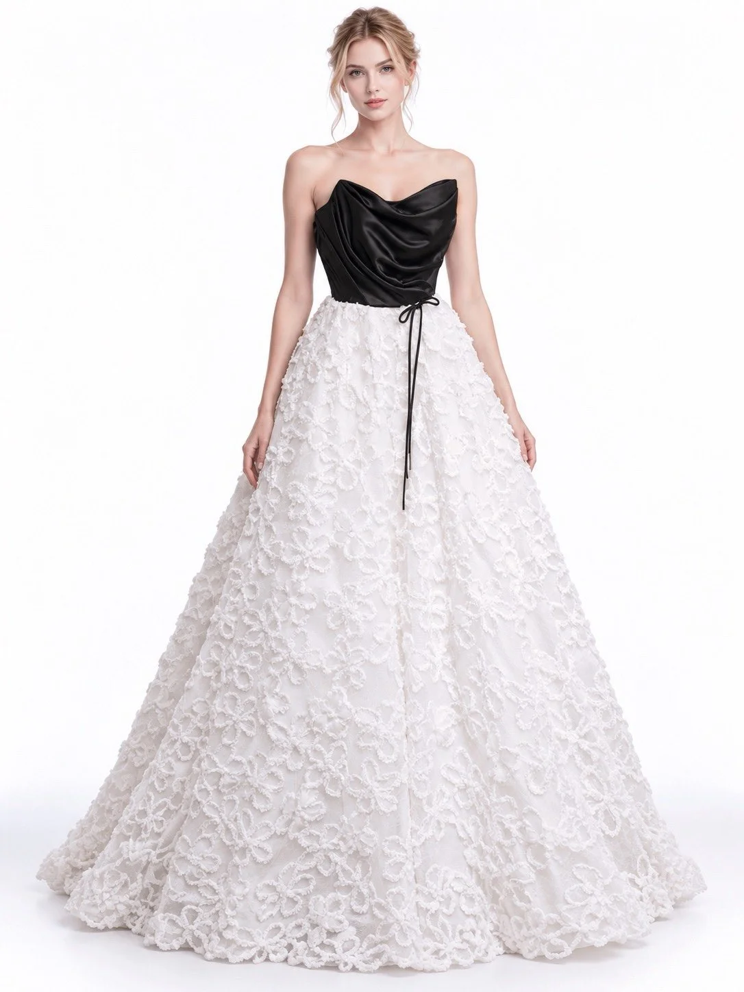 A woman wearing a strapless black satin top and a full white lace bridal gown with floral embroidery.