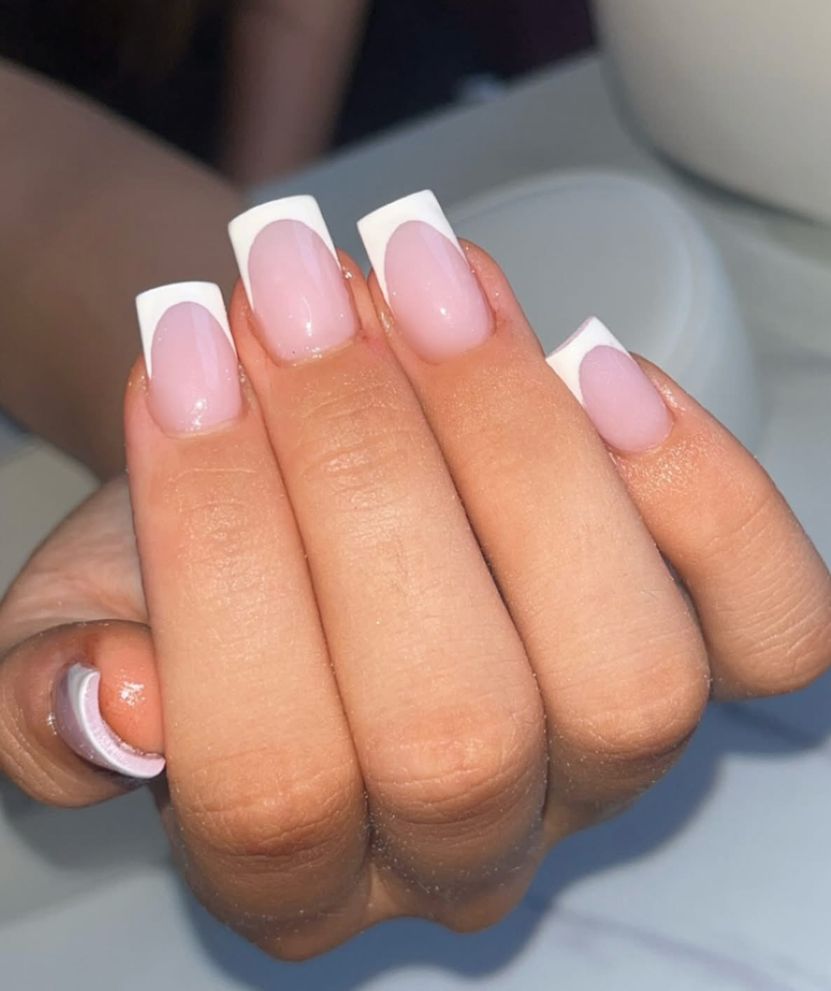 Classic white French-tip square nails with a glossy pink base.