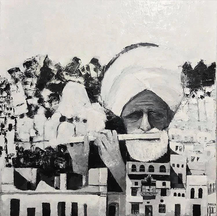 A black and white mural of a man with a turban playing a flute, with city buildings in the background.