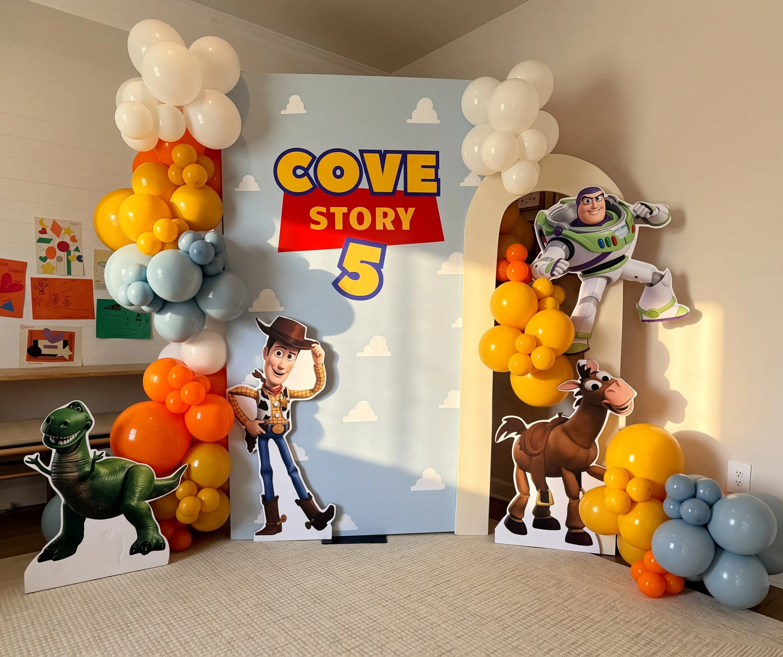 Decorative backdrop with balloons and character cutouts from Toy Story for a children's party or event.