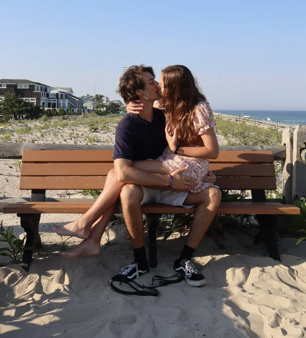 Couple Kissing on Bench at the Beach