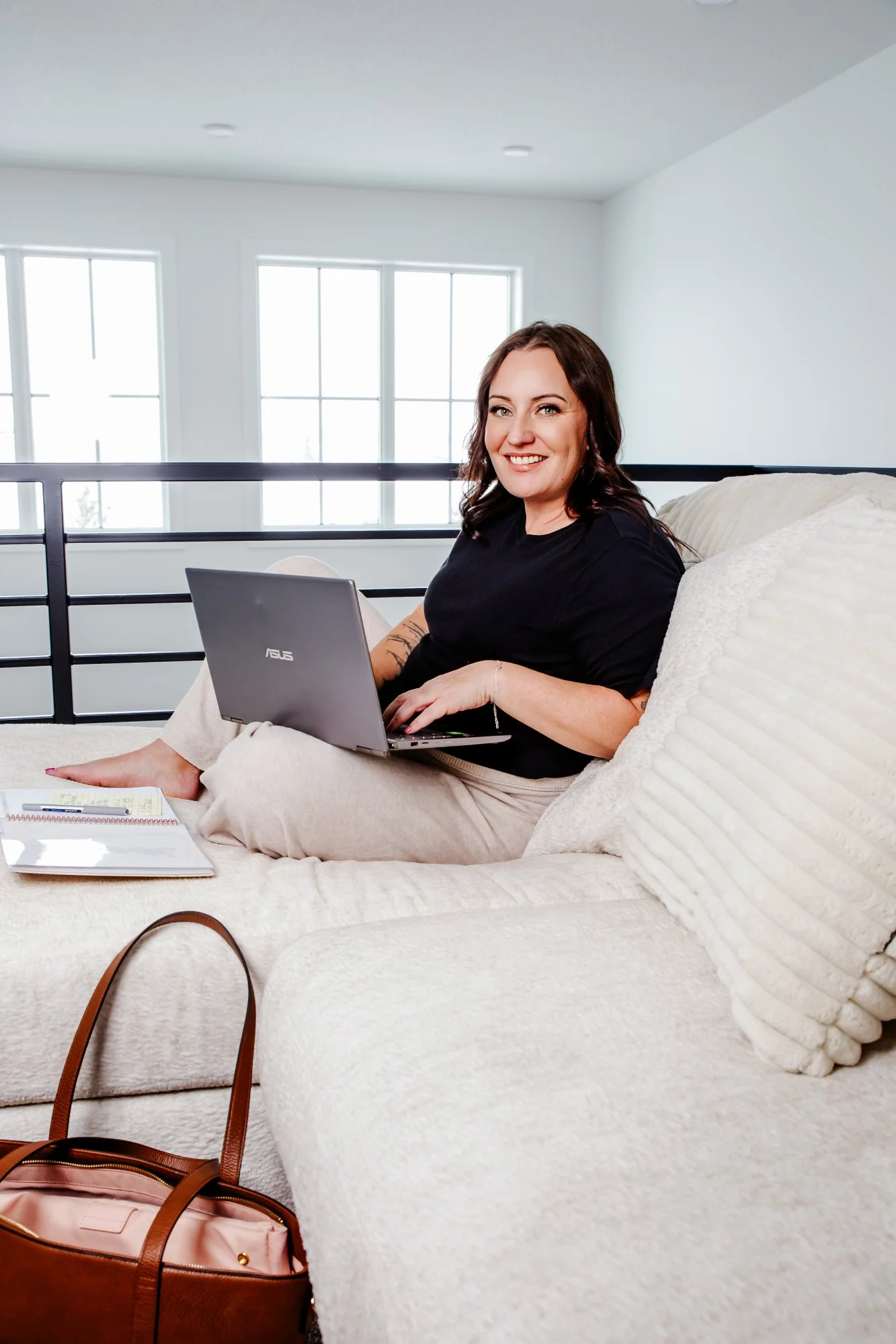 Anna Tonery of Mortgage with Anna working remotely with mortgage and financing clients from her laptop.