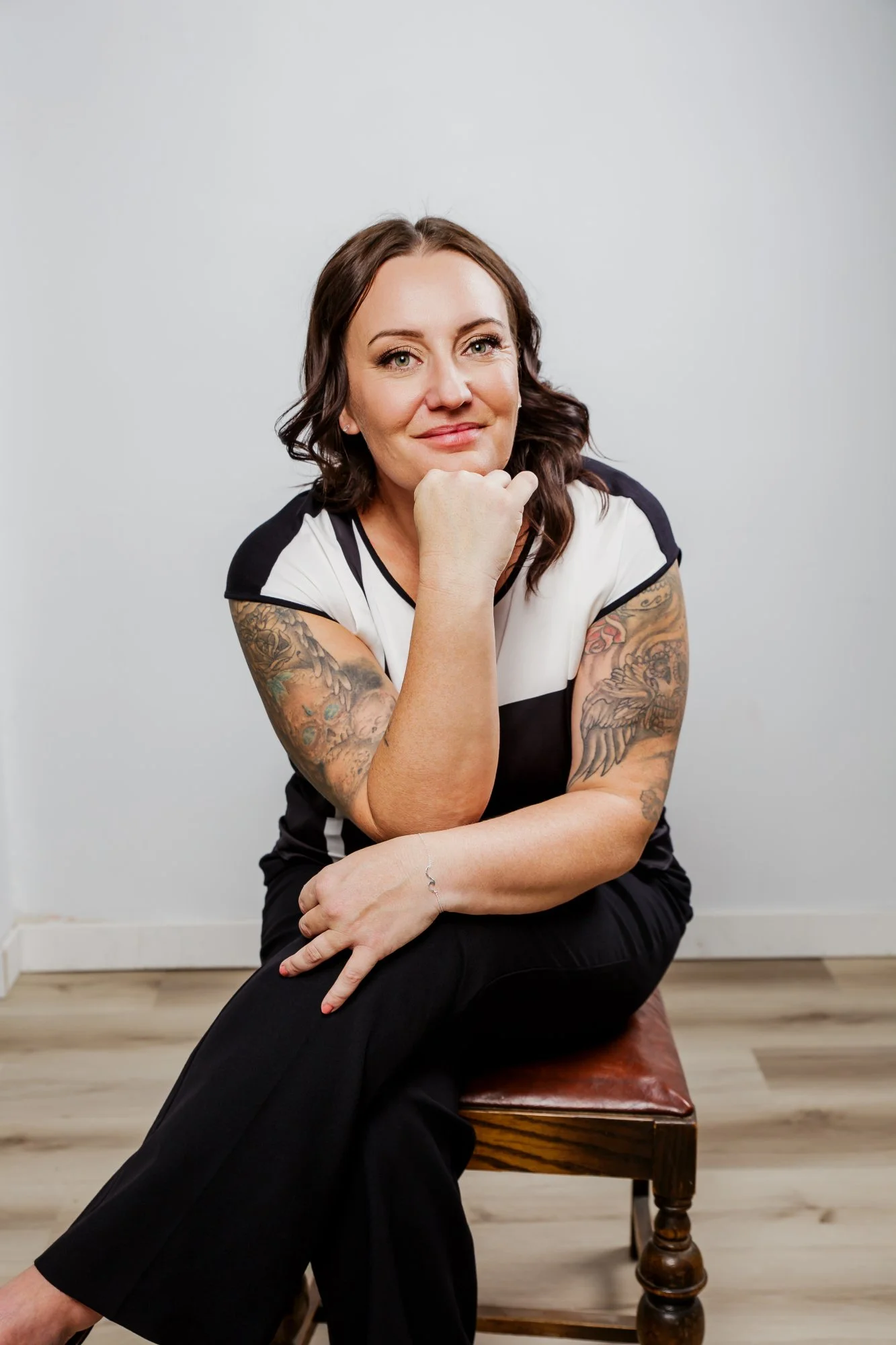 Anna Tonery, mortgage broker with Mortgage with Anna, seated and smiling in a casual portrait.