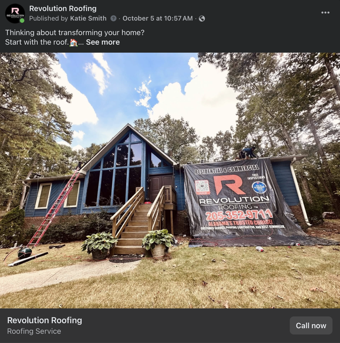 Roofing contractors working on a blue A-frame house with a Revolution Roofing banner and ladder in the front yard