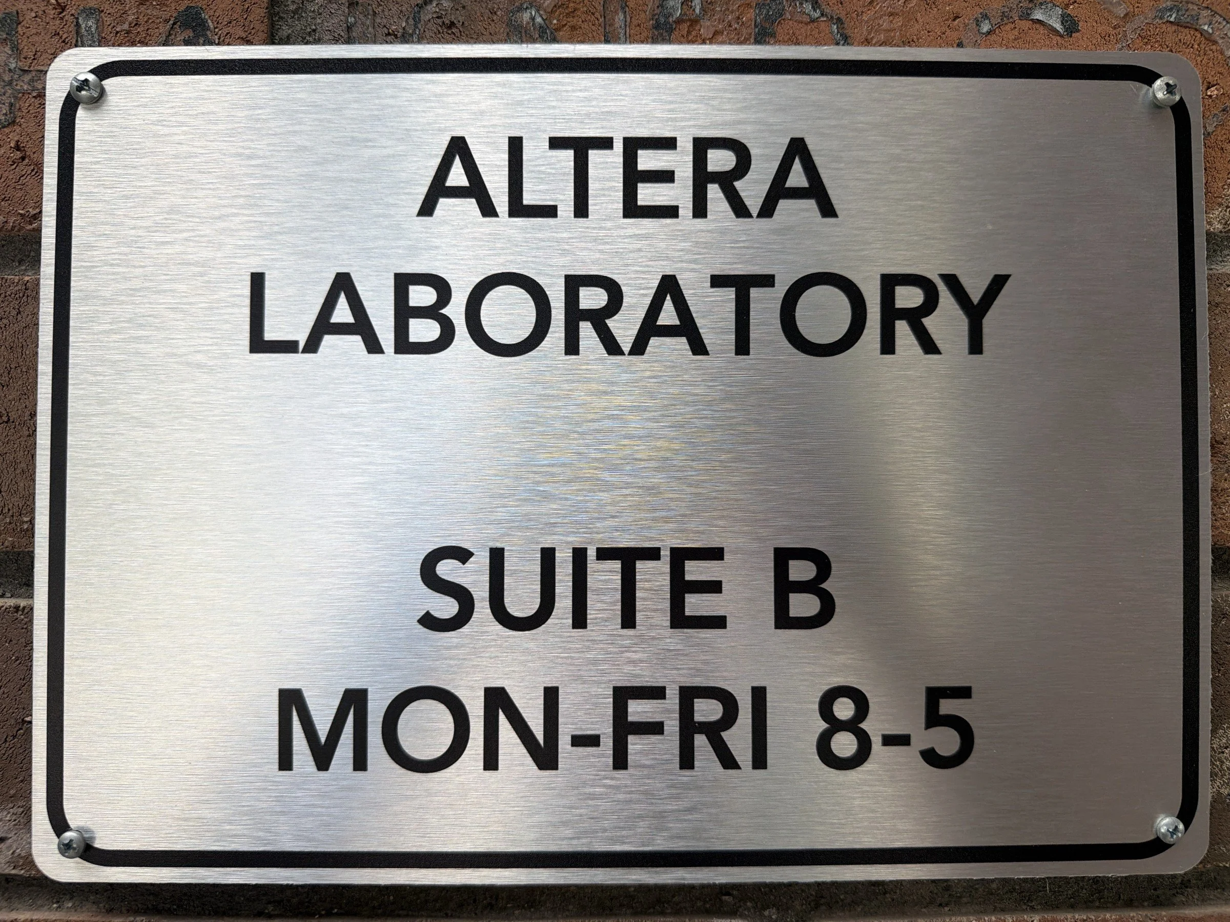 Silver ALTERA LABORATORY SERVICES suite sign, Suite B, Monday-Friday 8-5