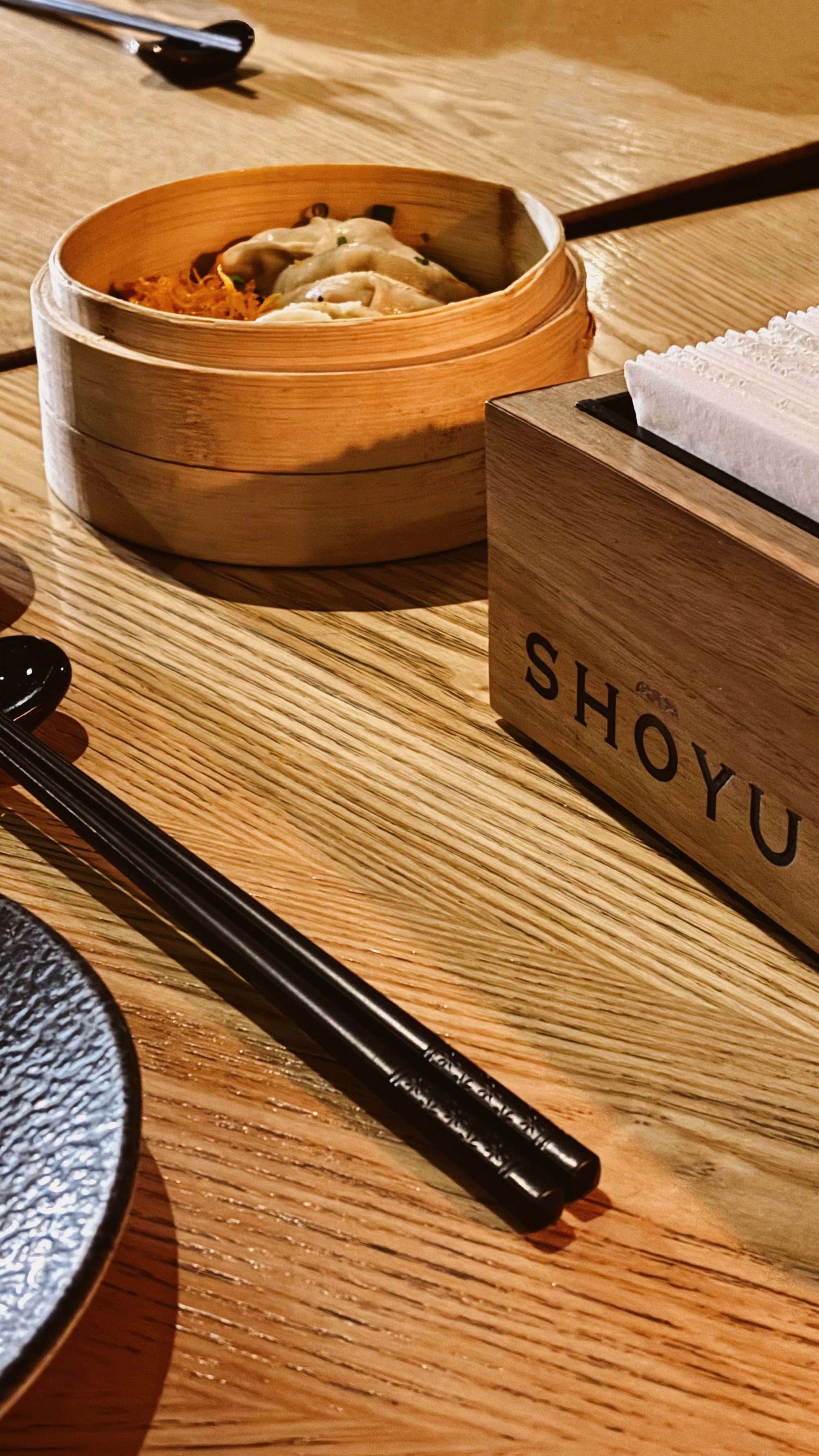 Gyosas y palillos en mesa de madera