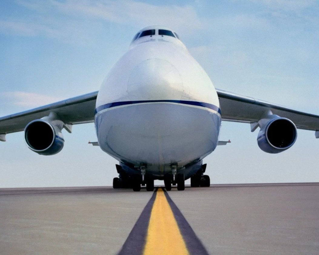 Front view of a large commercial airplane on a runway