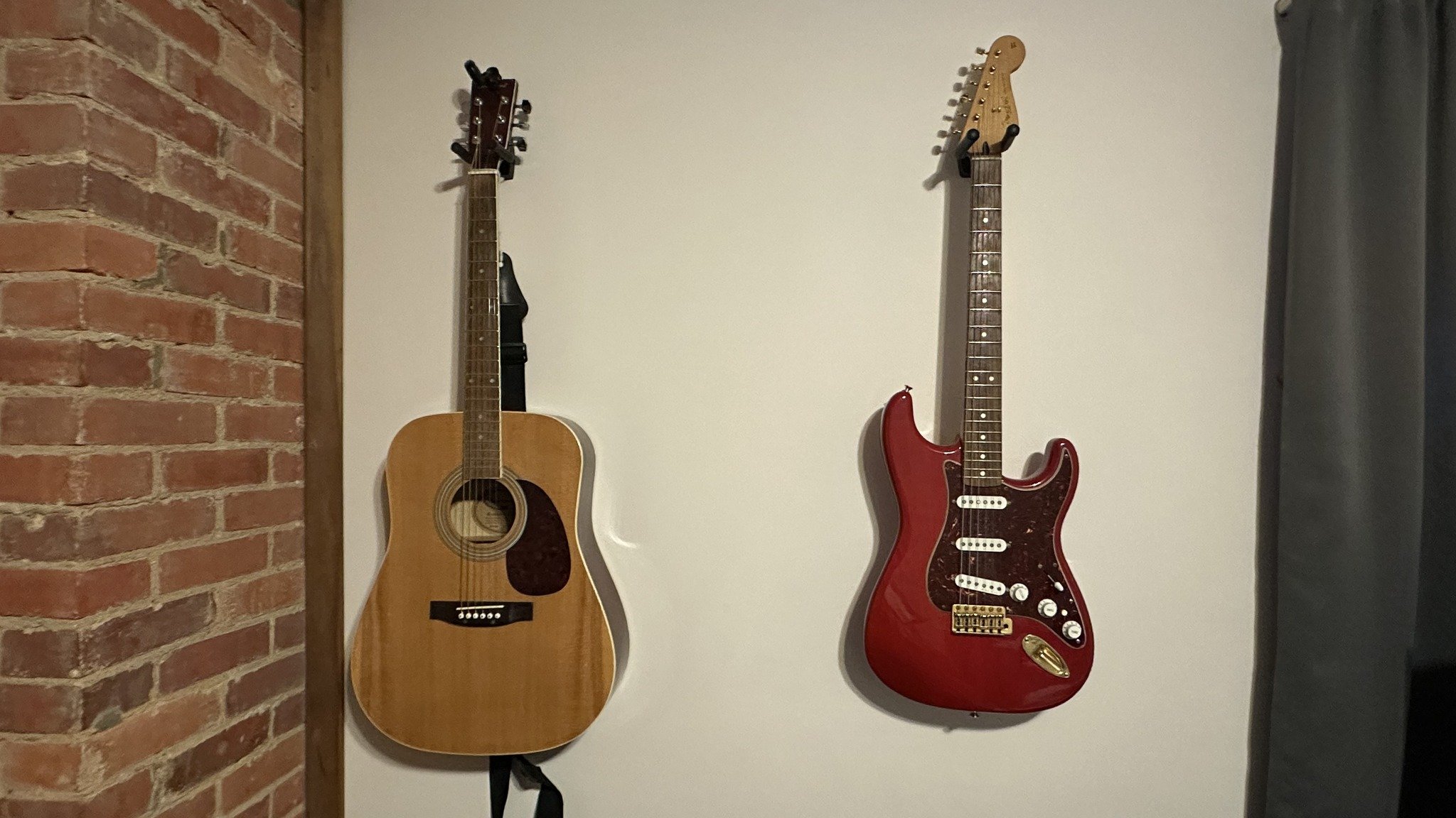 Electric and acoustic guitars on wall