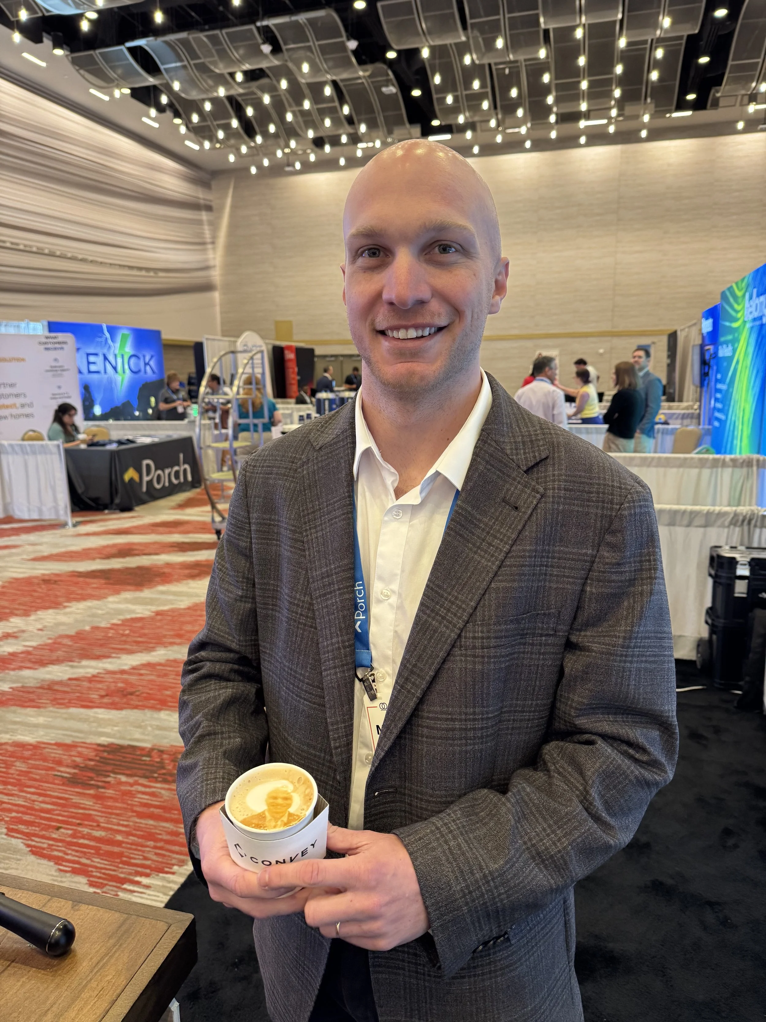 Conference guest holding a latte served at a Hebrews Coffee Co. corporate espresso bar