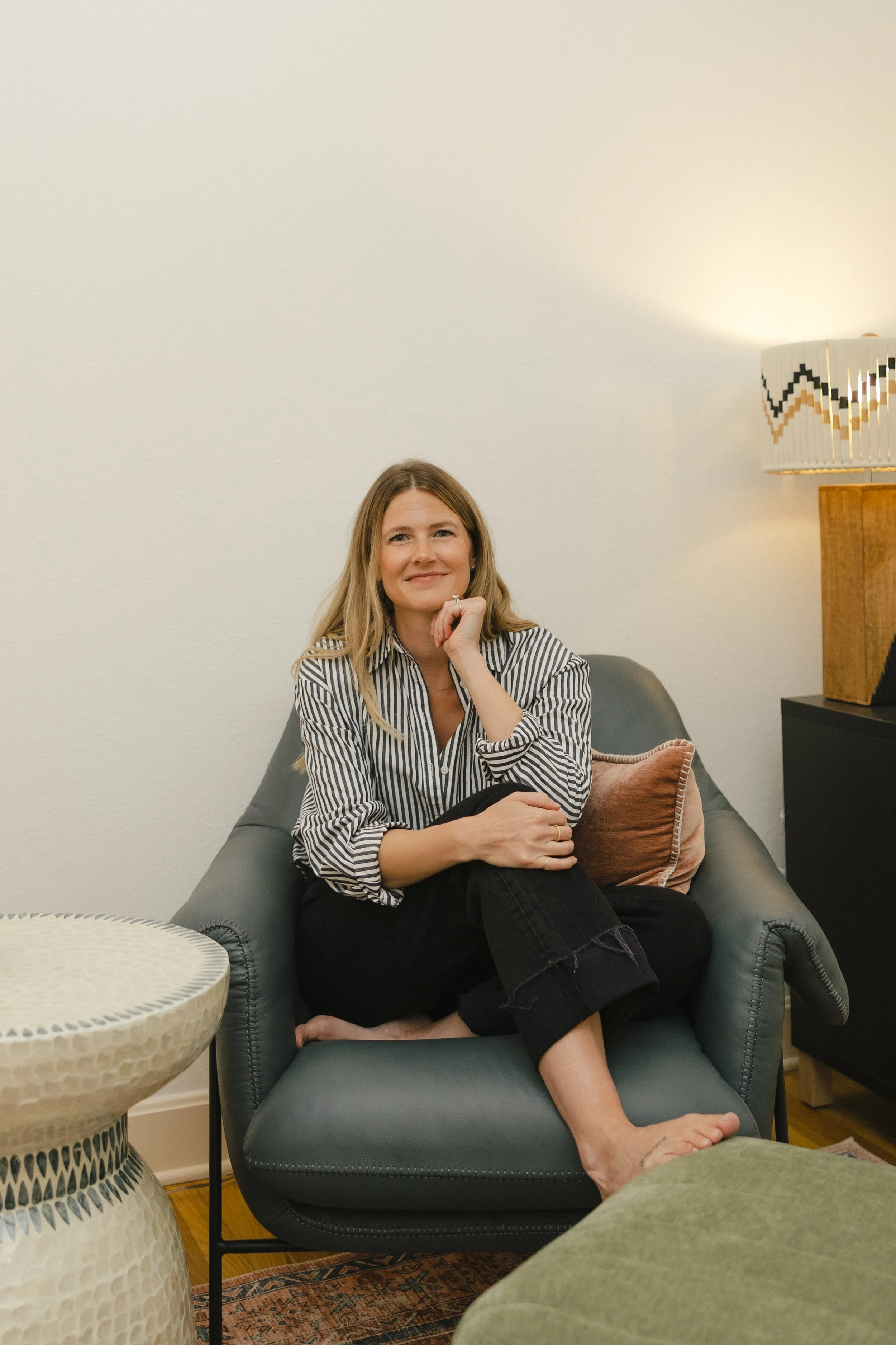 Therapist Chanelle Johnson seated in an armchair in her Kansas City office.