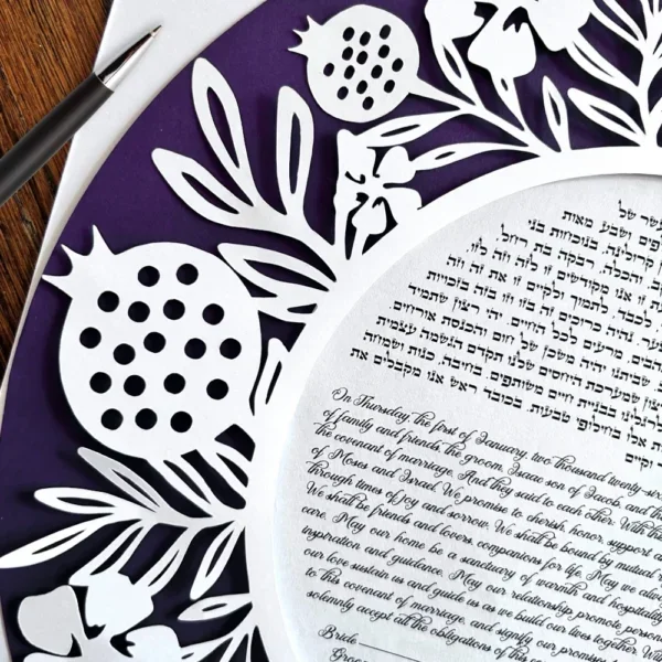 close-up-of-ketubah-and-pen-600x600.webp