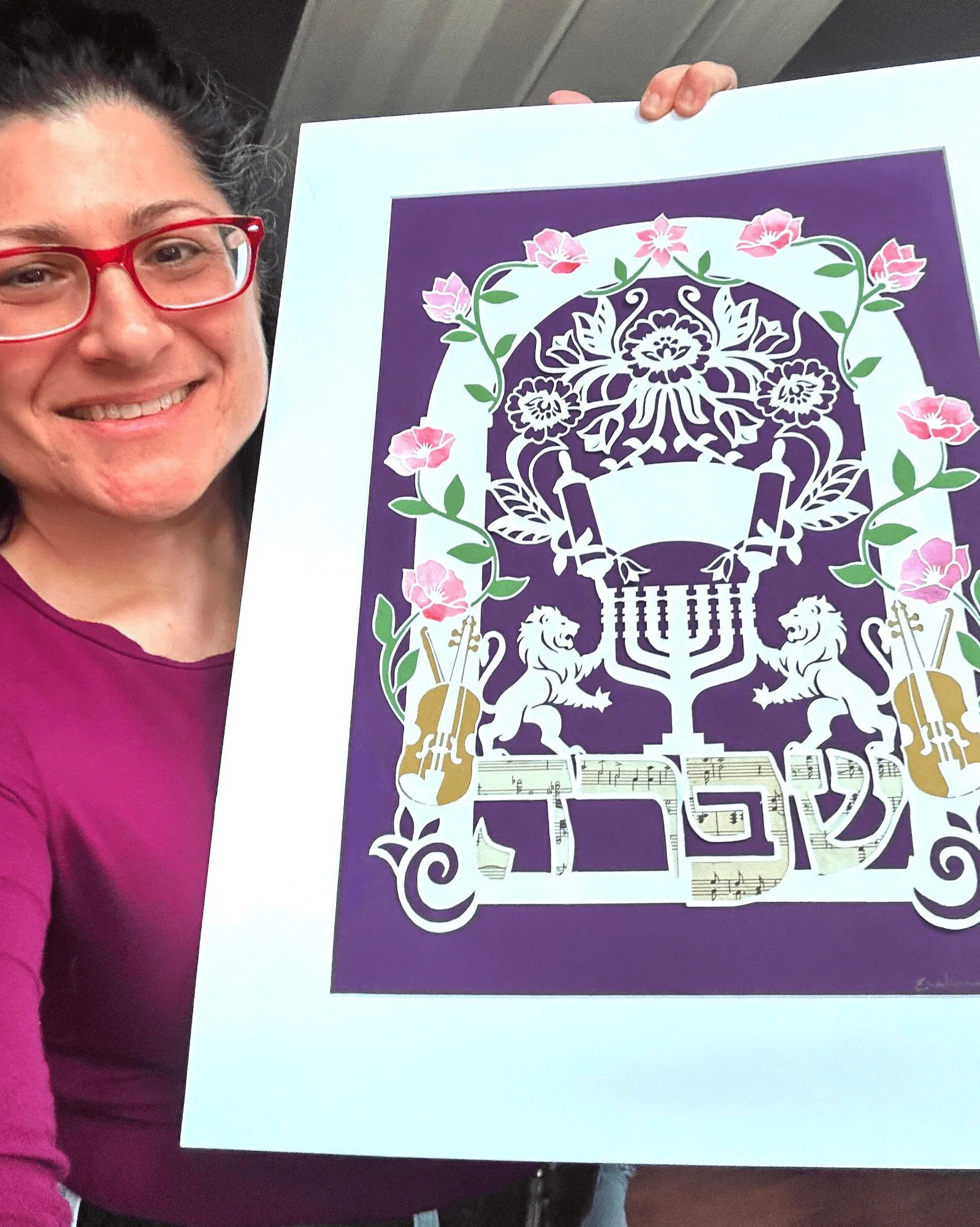 evelyn holding up a custom commission judaica piece
