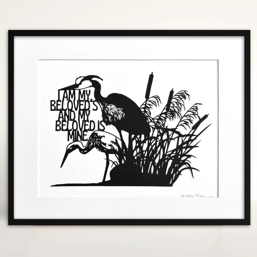 Black papercut artwork depicting two herons in a marsh setting with cattails and reeds. The artwork includes English text and is set against a white background. The herons are in silhouette.