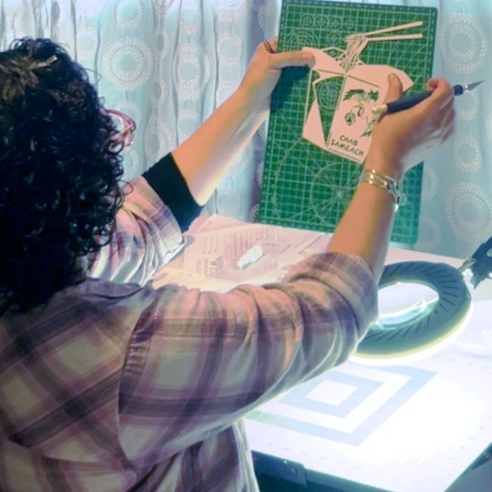 Evelyn holding up a papercut she is working on