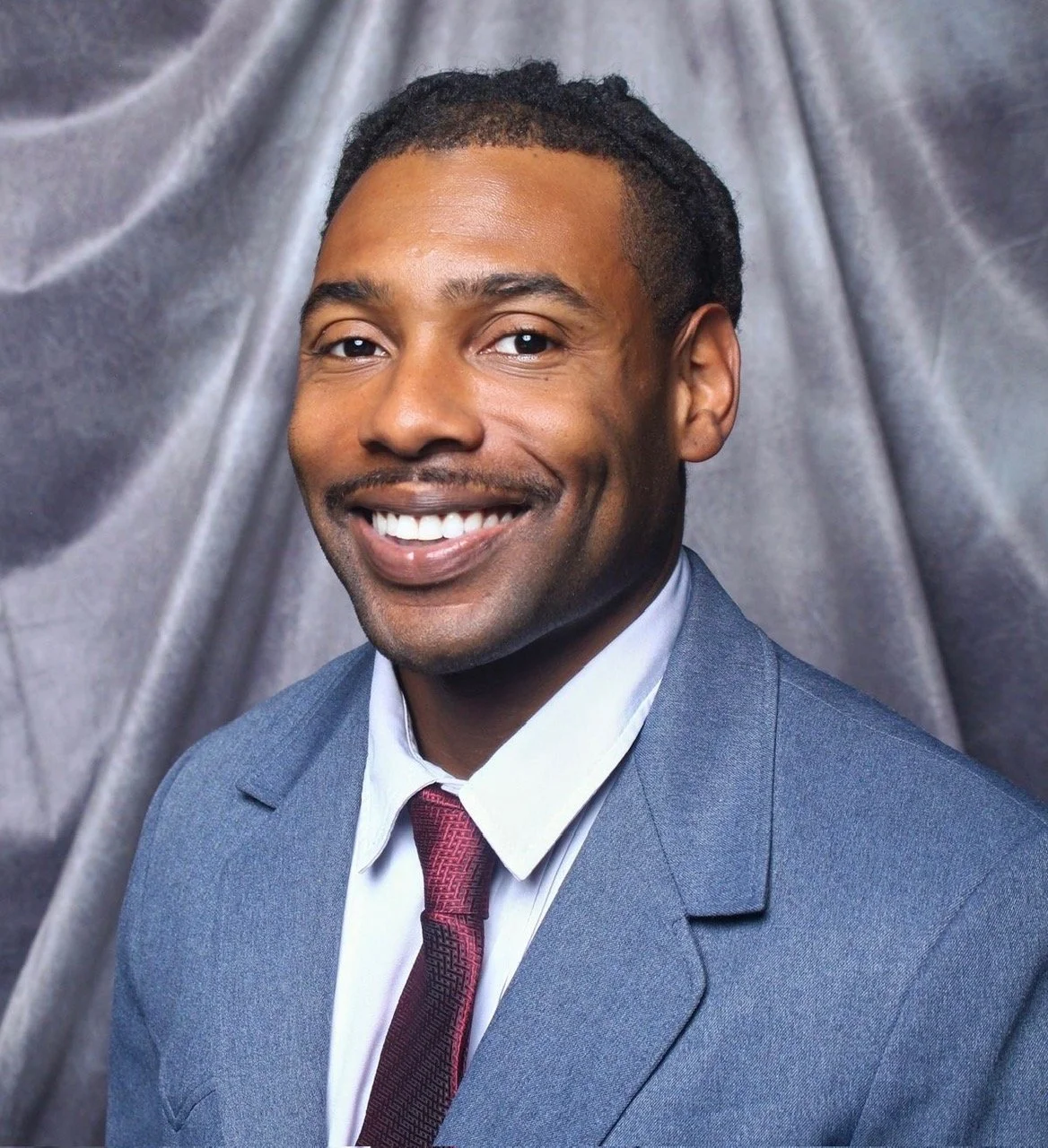 Professional portrait of speaker, moderator, and emcee Keenan Medlock.